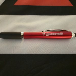 A red matte pen with chrome accents and the National Esports Tournament logo printed on the barrel.